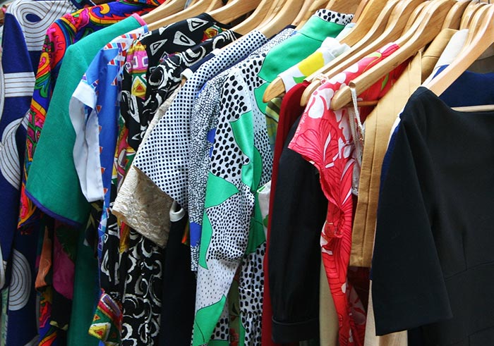 Brightly colored dresses hanging on a rack