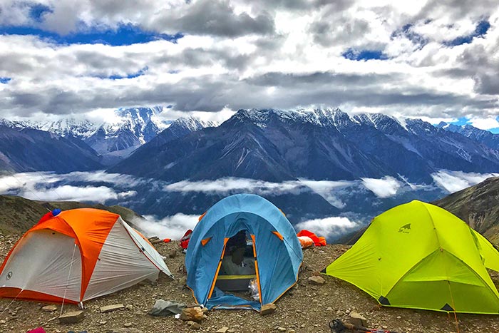 Three tents pitched on the landing of a mountain